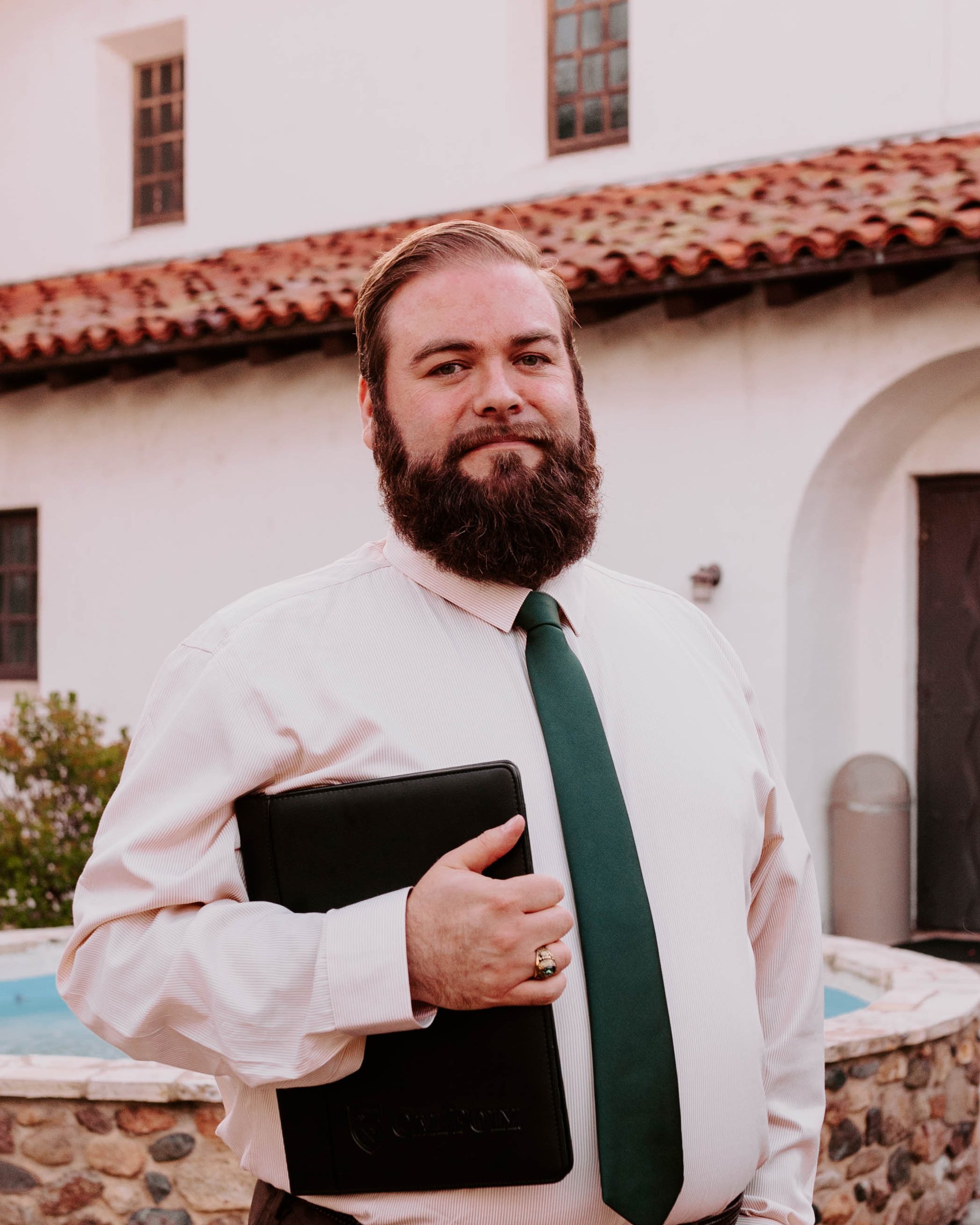 Independent journalist Joe Payne standing at Mission San Luis Obispo, California.